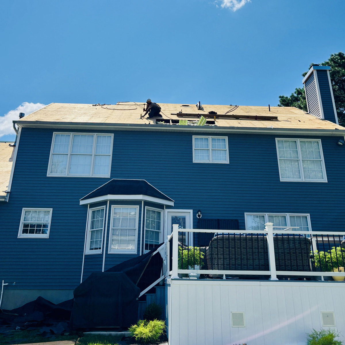 Fresh roof decking on a Jersey Shore home mid-job